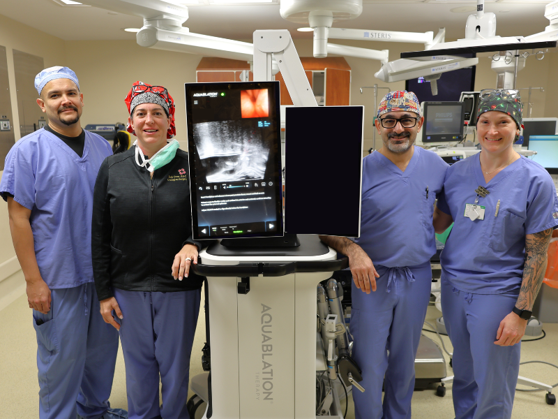 Health care providers standing beside new aquablation system