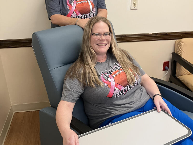 Patient Seated in new infusion chair; other person standing behind